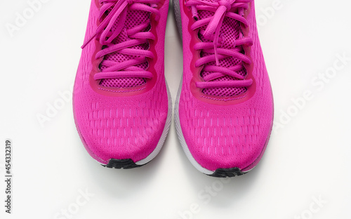 pair of purple textile sneakers on a white background, top view. Shoes for sports