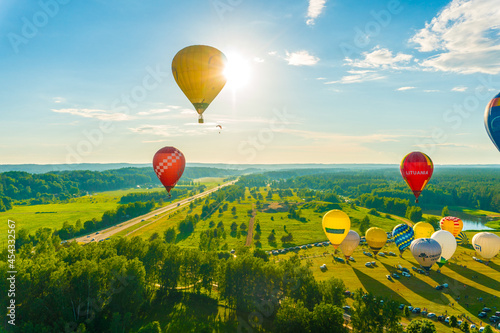 Aerial landscape view with colorful hot air balloons 