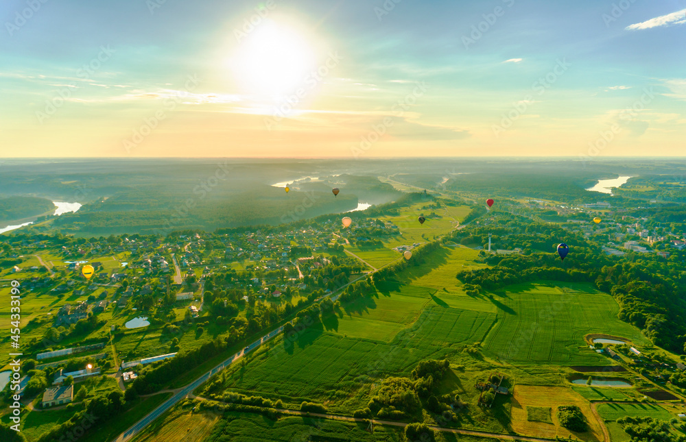 Aerial landscape view with colorful hot air balloons
