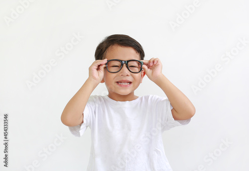 Smiling asian little boy child wearing glasses isolated on white background