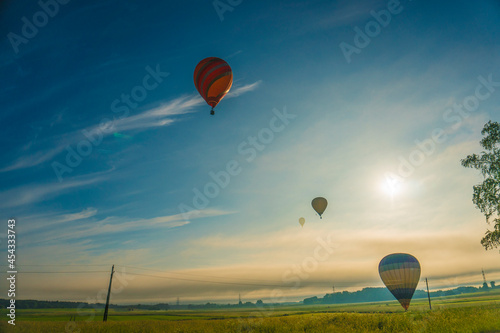 hot air balloons over rural landscape