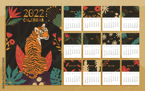 2022 year calendar concept with  hand drawn illustrations of tiger and jungle leaves.