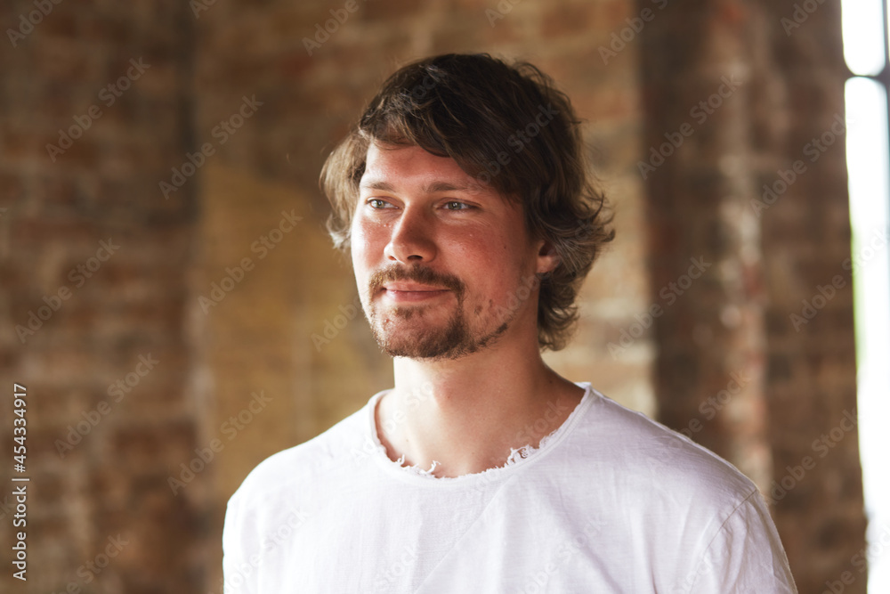 Smiling, bearded entrepreneur leader looking into the camera in a modern loft office. A business portrait of a satisfied young freelancer, a professional blogger. Smiling, bearded entrepreneur leader looking into the camera in a modern loft office. A business portrait of a satisfied young freelancer, a professional blogger.