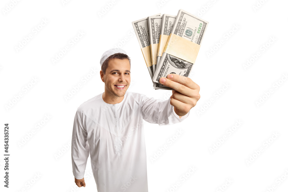 Young man in white ethnic clothes showing money in front of camera Young man in white ethnic clothes showing money in front of camera