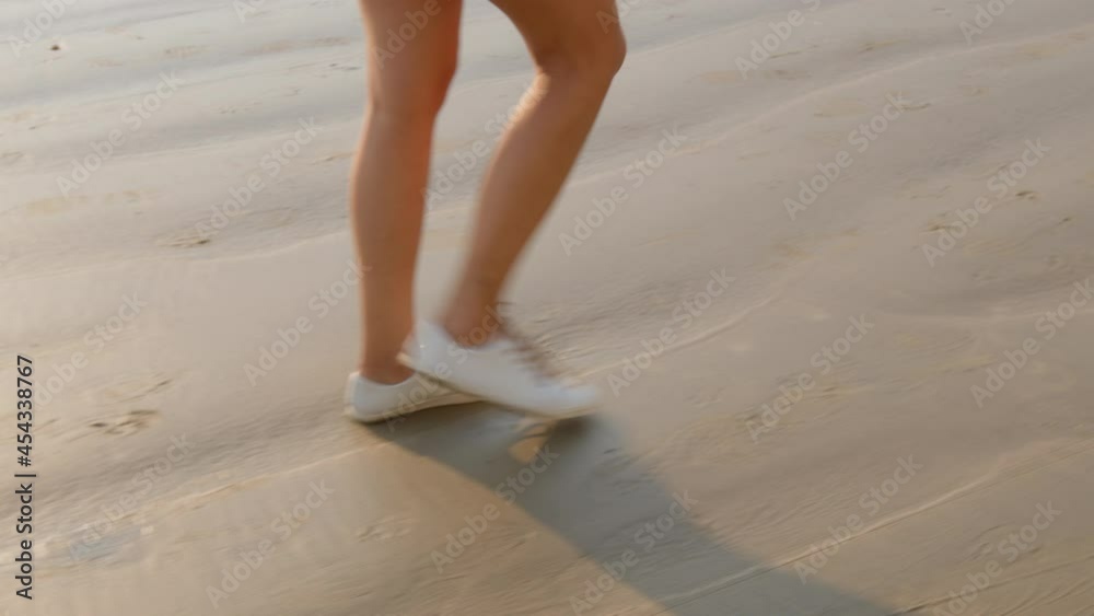 Detail image of woman walking at Balneário Camboriú beach, Brazil.