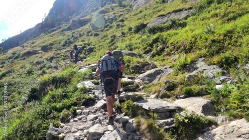 Lac Blanc hiking. Hikers reach Lac Blancs in Chamonix France.  One of the most popular destination for hikers in Chamonix