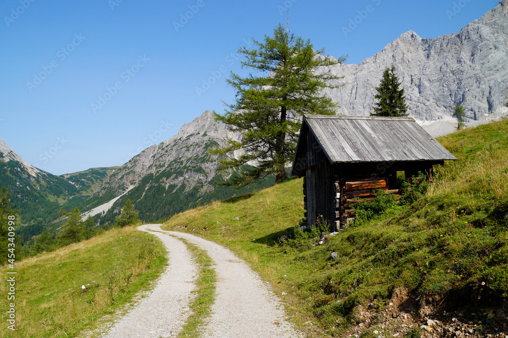 a pathway leading through the alpine country side of the Schladming-Dachstein region in Austria