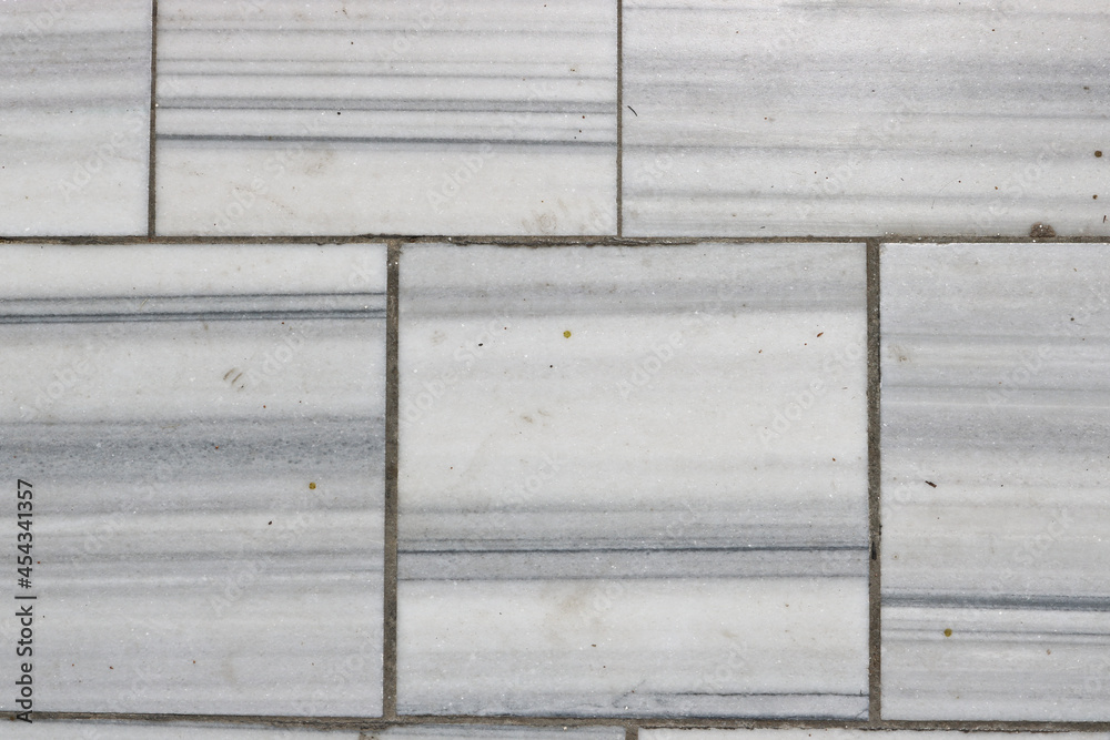 Natural marble texture - pavement paved with marble slabs. Marble background. Natural marble texture - pavement paved with marble slabs. Marble background.