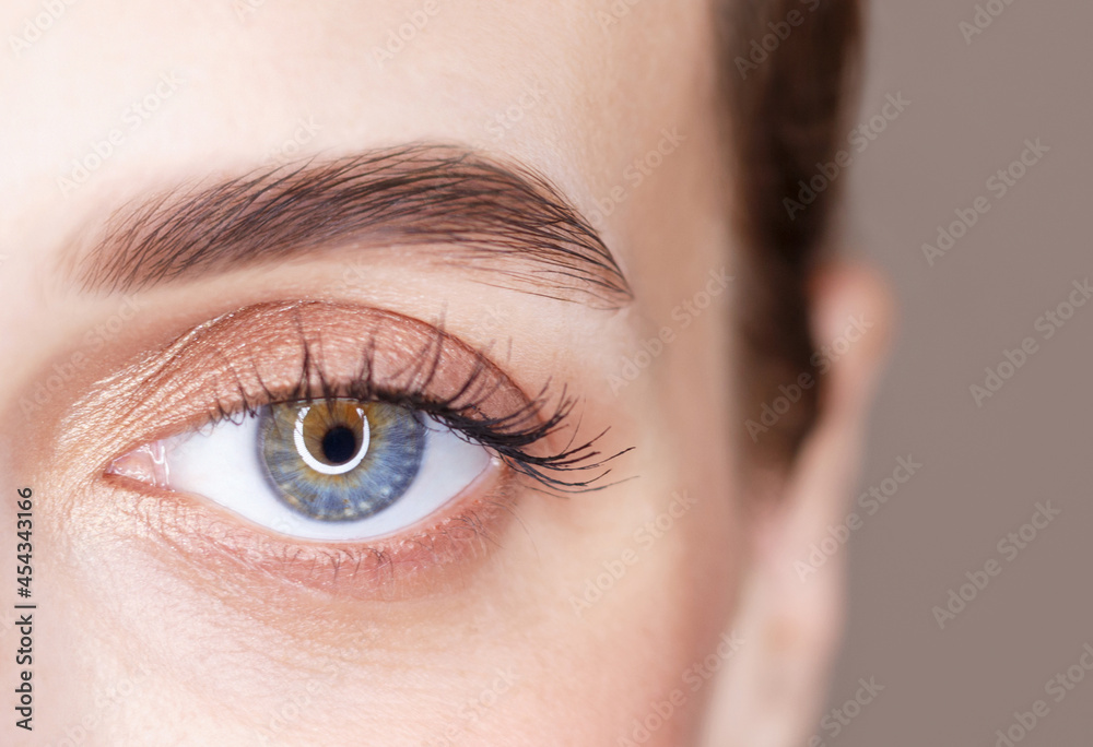 Obraz premium A blue eye beautiful young woman close-up, vision concept.