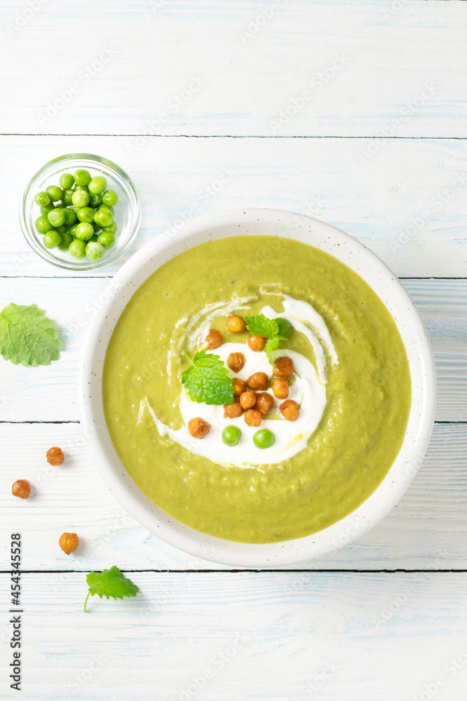 classic split pea soup with roasted chickpeas on wooden background. Top view, copy space. classic split pea soup with roasted chickpeas on wooden background. Top view, copy space.