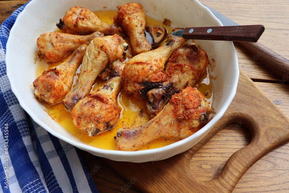 Roasted chicken legs with herbs in the pan Roasted chicken legs with herbs in the pan