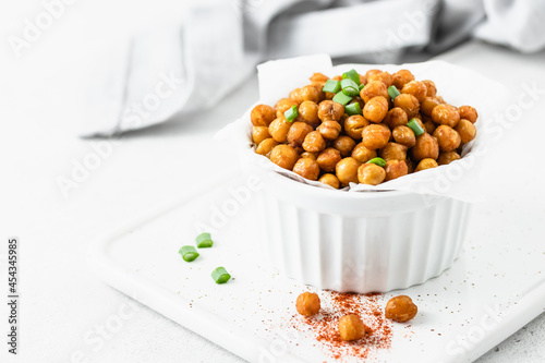 Baked smoked paprika spicy chickpea in a bowl. Space for text.