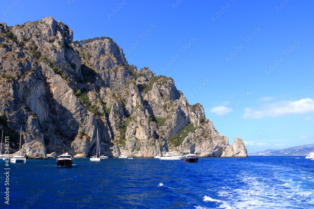 Boats of all sizes moored near the coastline of the island of Capri, Italy