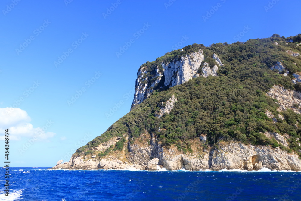 Boats of all sizes moored near the coastline of the island of Capri, Italy