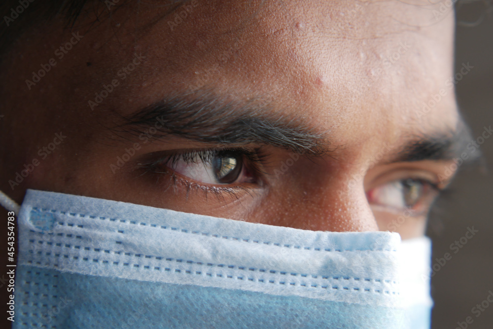 Close up of man with protective face mask looking at camera Close up of man with protective face mask looking at camera