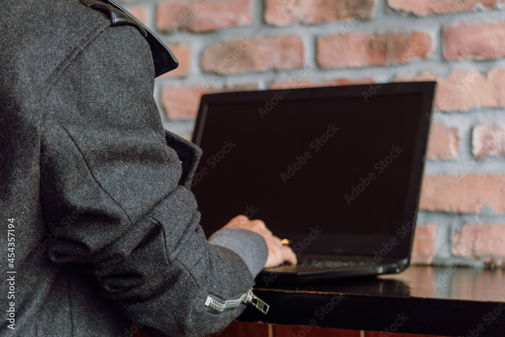 Woman sitting at table and using laptop Woman sitting at table and using laptop