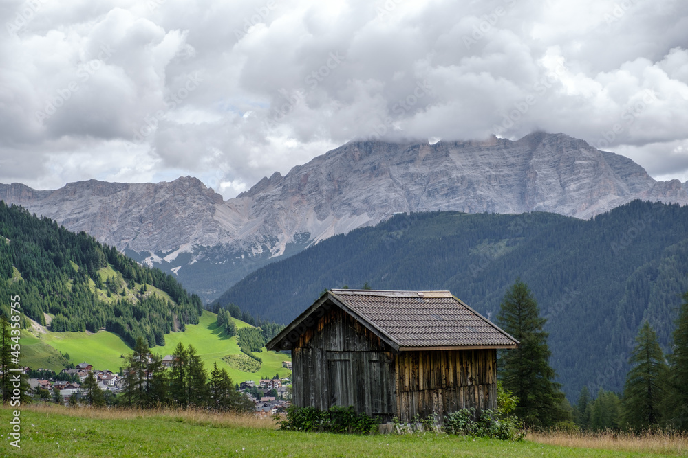 Alta Badia (Dolomiti) - August: Beautiful summer mountain view of Passo Sella and high peak Sassopiatto and Sassolungo, Langkofel, Dolomiti, Sella group. Green meadows and pastures, alpine dolomites