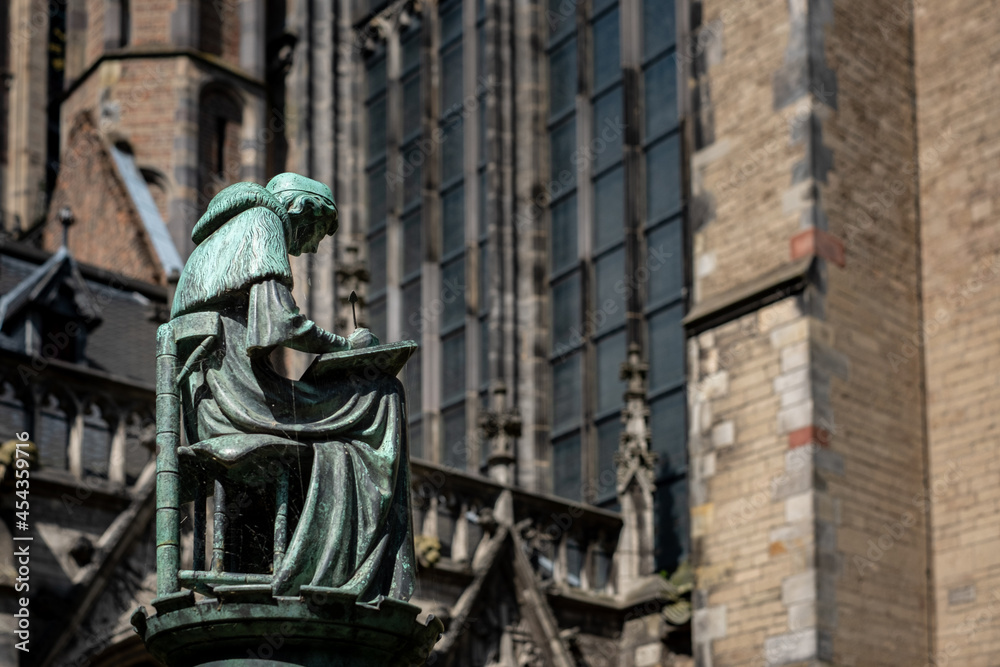 Obraz premium Statue writing monk in the Dom Garden of Utrecht, Utrecht Province, The Netherlands