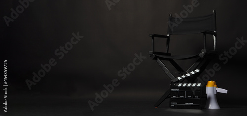 Black director chair and Clapper board or movie Clapperboard with megaphone on black background.