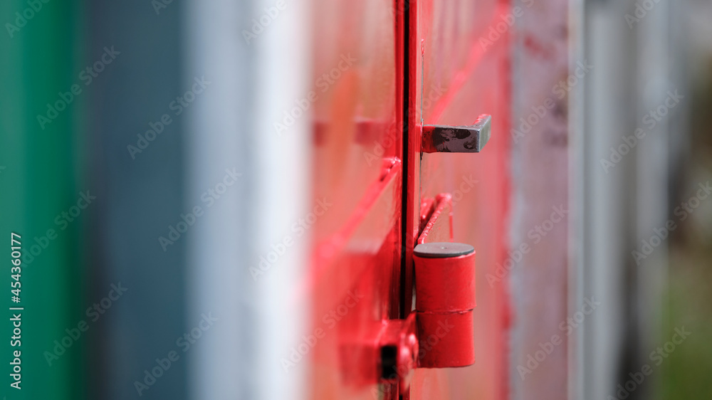 Locked red door detail with a shallow depth of field