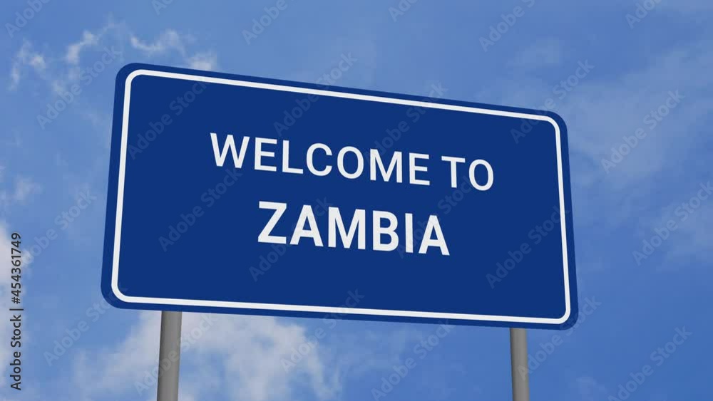 Welcome to Zambia Road Sign on Clear Blue Sky with Rapid Moving Clouds Welcome to Zambia Road Sign on Clear Blue Sky with Rapid Moving Clouds