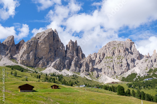 Alta Badia (Dolomiti) - August: Beautiful summer mountain view of Passo Sella and high peak Sassopiatto and Sassolungo, Langkofel, Dolomiti, Sella group. Green meadows and pastures, alpine dolomites