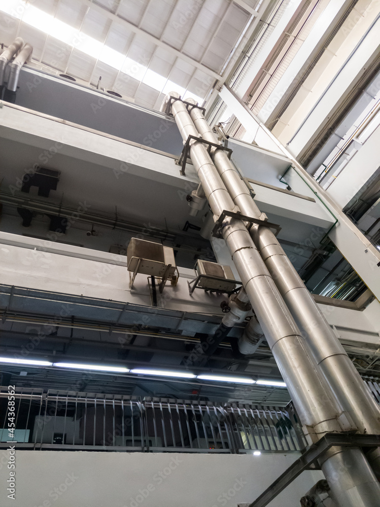 The complex metal pipe of the ventilation system along the terrace to the top of the building. The complex metal pipe of the ventilation system along the terrace to the top of the building.