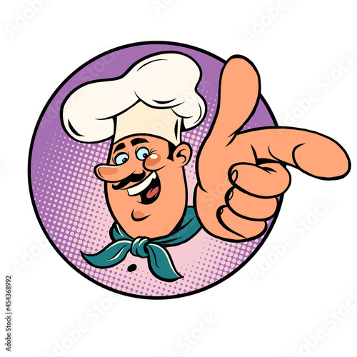 Man chef in a white cap. Smiling face. Professional points a finger