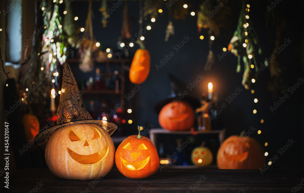 Fototapeta premium Halloween pumpkins on old wooden table on background Halloween decorations