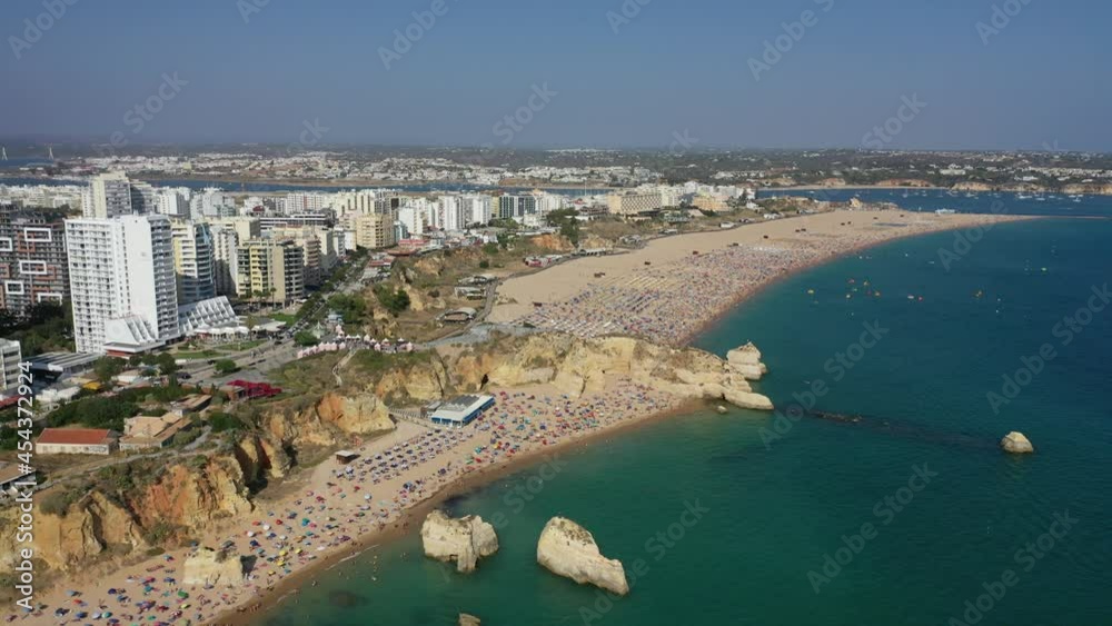 Aerial view of crowded Rocha beach in Portimao, Algarve, Portugal Aerial view of crowded Rocha beach in Portimao, Algarve, Portugal