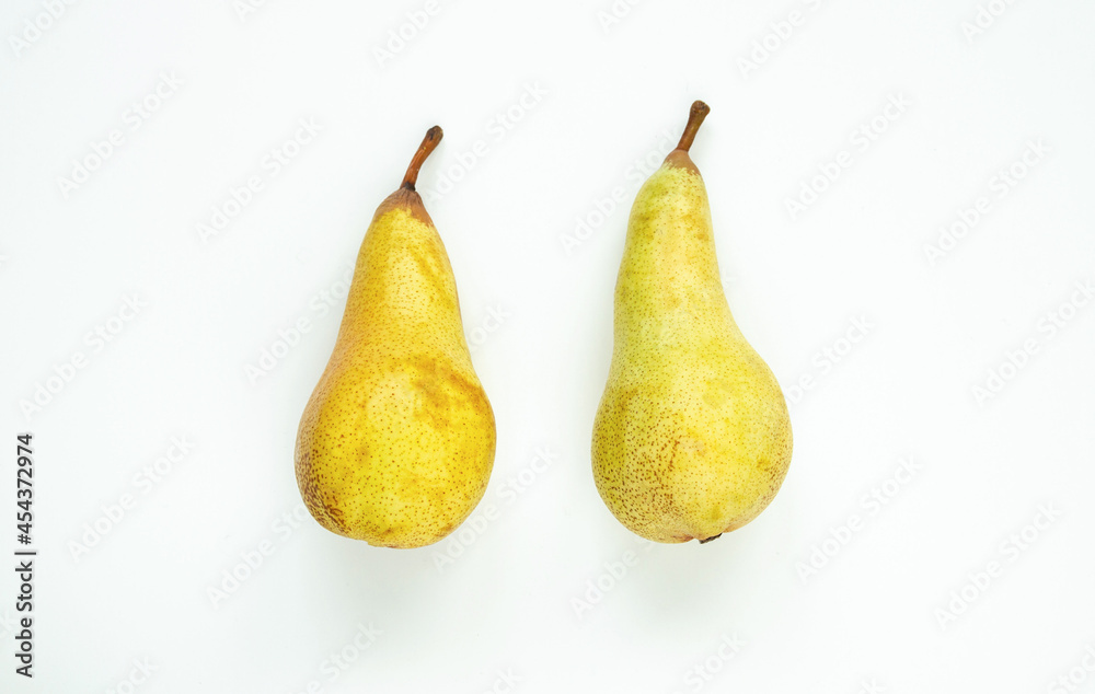 Two healthy, delicious pears on a white background, flat lay composition. Two healthy, delicious pears on a white background, flat lay composition.