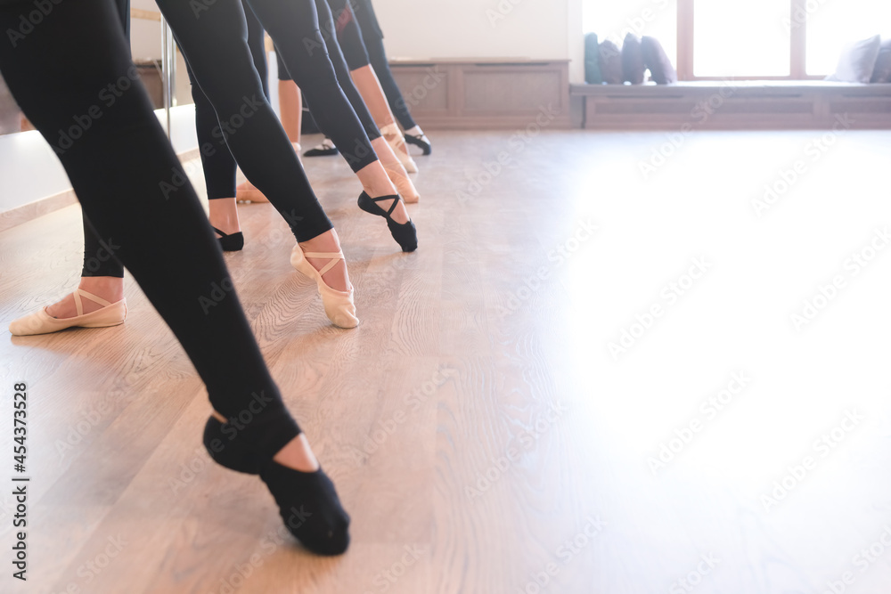 The elegant legs of ballet dancers standing in a row on their toes The elegant legs of ballet dancers standing in a row on their toes