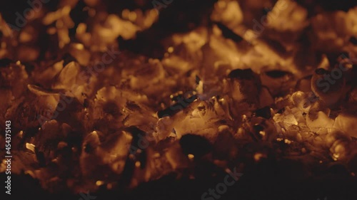 Close-up of glowing red coals in slow motion