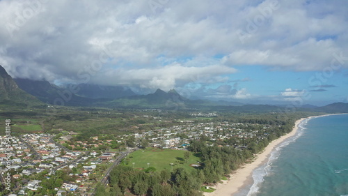 Colorful aerial view of rocky mountains. A tropical beach with turquoise blue ocean water and waves lapping on a hidden white sandy beach. Waimanalo Beach, Oahu Island, Hawaii. © dualpics