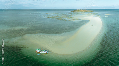 Sand Beach Island, Wild islands of Indonesia. tropical paradise. Tanjung Luar. drone shooting. Wild beaches, blue lagoons, coral reefs. aerial drone view. boat trip safari. 