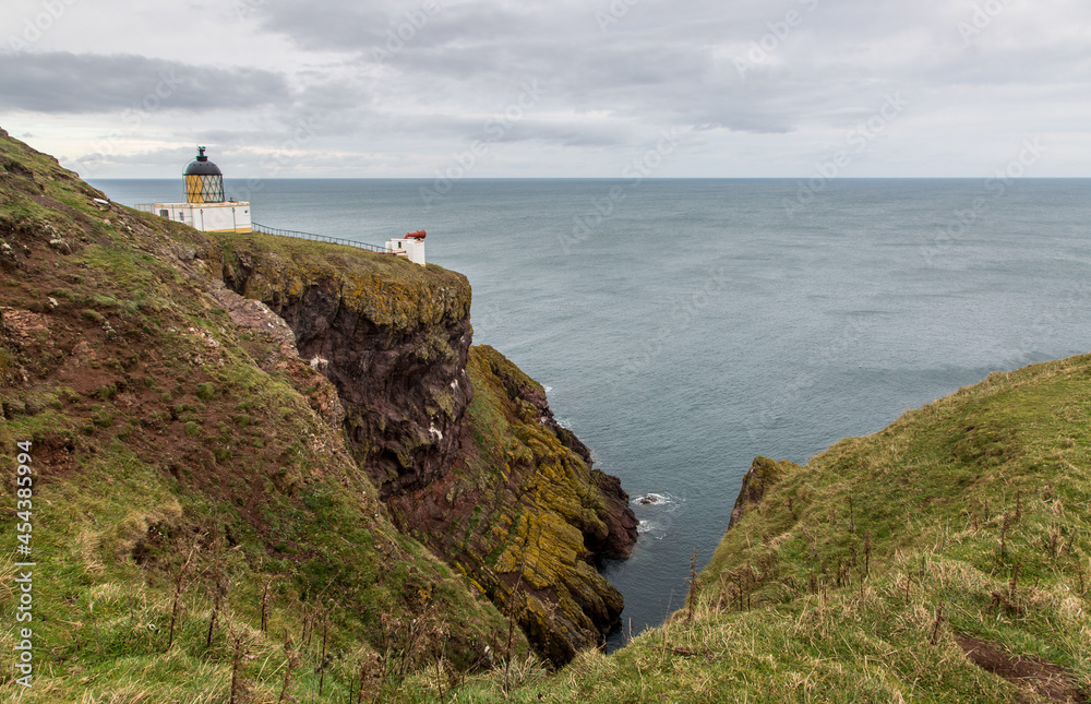 The Lighthouse and foghorn of St Abbs Head Lighthouse, perched on the cliff edge above the North Sea in Berwickshire, Scotland