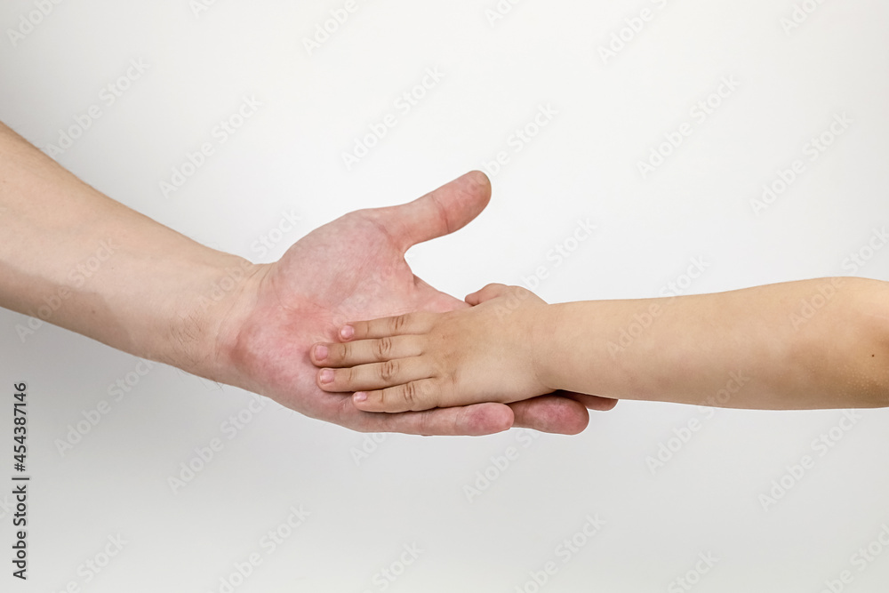 the concept of children's trust in an adult, the concept of kindness and care, a child's hand lies in the hand of a man the concept of children's trust in an adult, the concept of kindness and care, a child's hand lies in the hand of a man