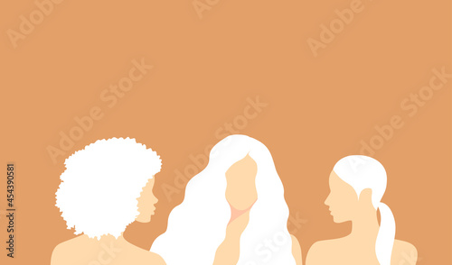 Three beautiful albino women on a soft orange background with copy space photo