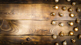 Golden Christmas balls on a wooden brown background.