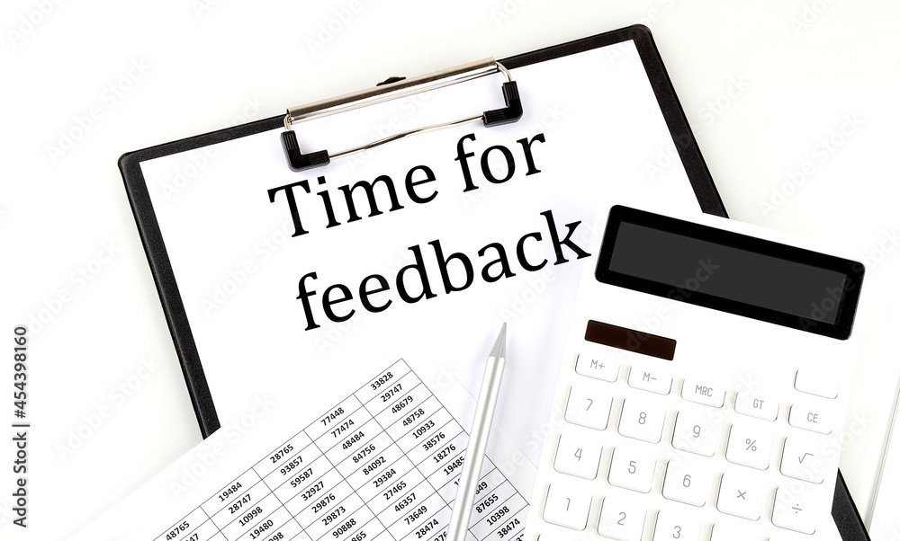 TIME FOR FEEDBACK text on folder with chart and calculator on white background