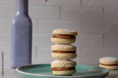 three alfajores on a green plate