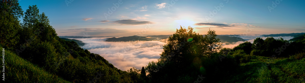 bright sunrise in the mountains with blue sky