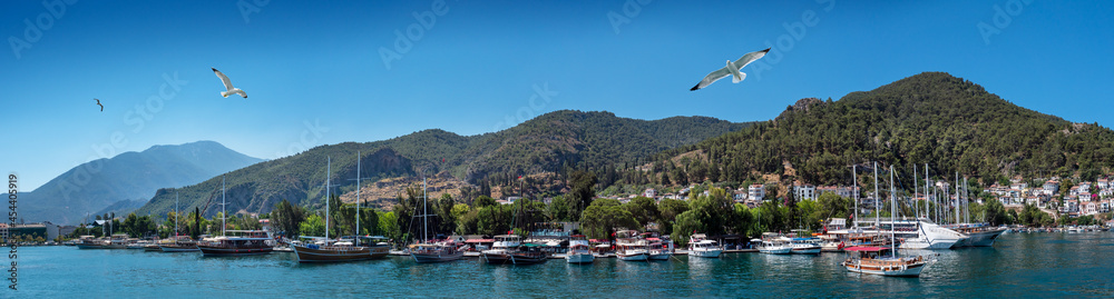 Panoramic landscape of the seaport of Fethiye, Turkey. Fethiye harbour with luxury sailboats and yachts on the Aegean coast.