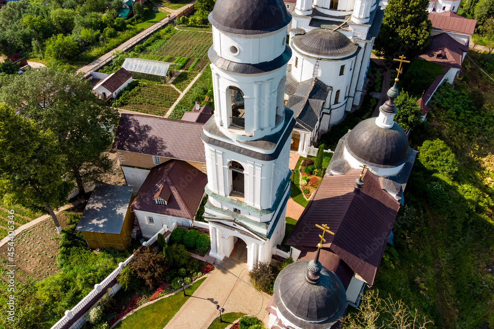 Bell tower and cathedral of the Orthodox Chernoostrovsky monastery in Maloyaroslavets, Russia, beautiful aerial view. June 2021