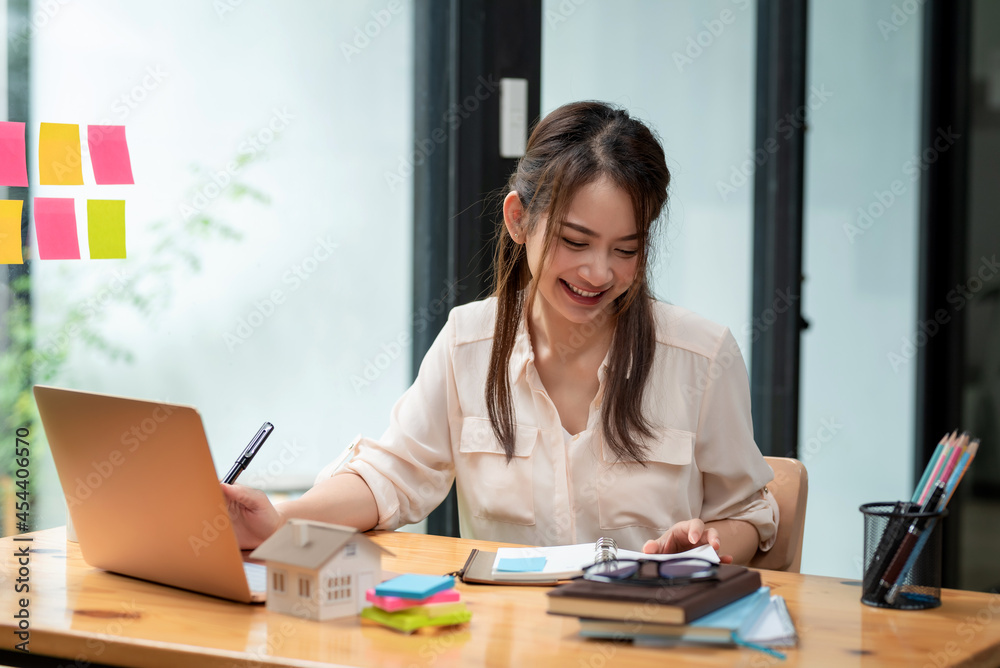 Beautiful smiling Asian businesswoman happy working at the office. Beautiful smiling Asian businesswoman happy working at the office.