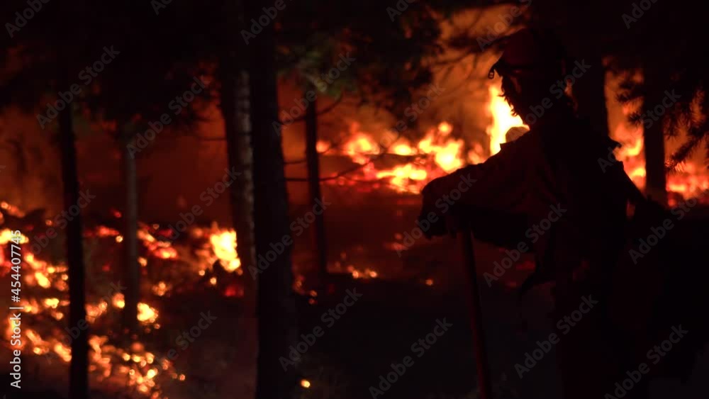 2021- Exhausted firefighters look on at night during the disastrous Dixie Fire in Northern California. 2021- Exhausted firefighters look on at night during the disastrous Dixie Fire in Northern California.