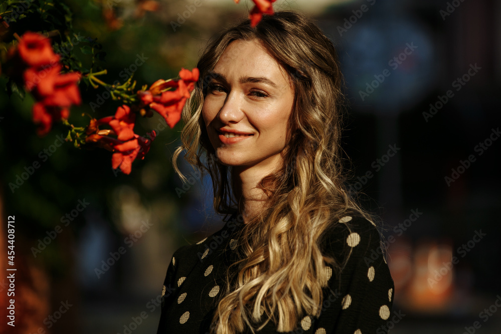 a girl with a bag walks around the city on a sunny day