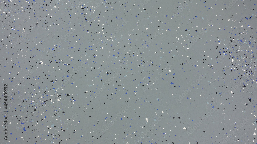 A freshly painted with a gray epoxy finish sprinkled with blue, black and white plastic chips. A freshly painted with a gray epoxy finish sprinkled with blue, black and white plastic chips.