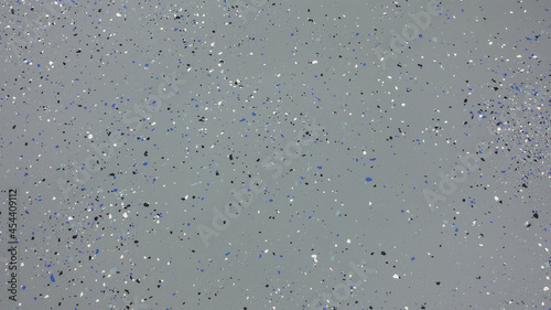 A freshly painted with a gray epoxy finish sprinkled with blue, black and white plastic chips.