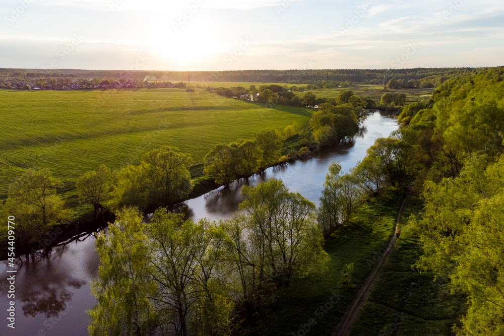 Bird's eye view of the river valley and flood meadows, picturesque landscape at sunset